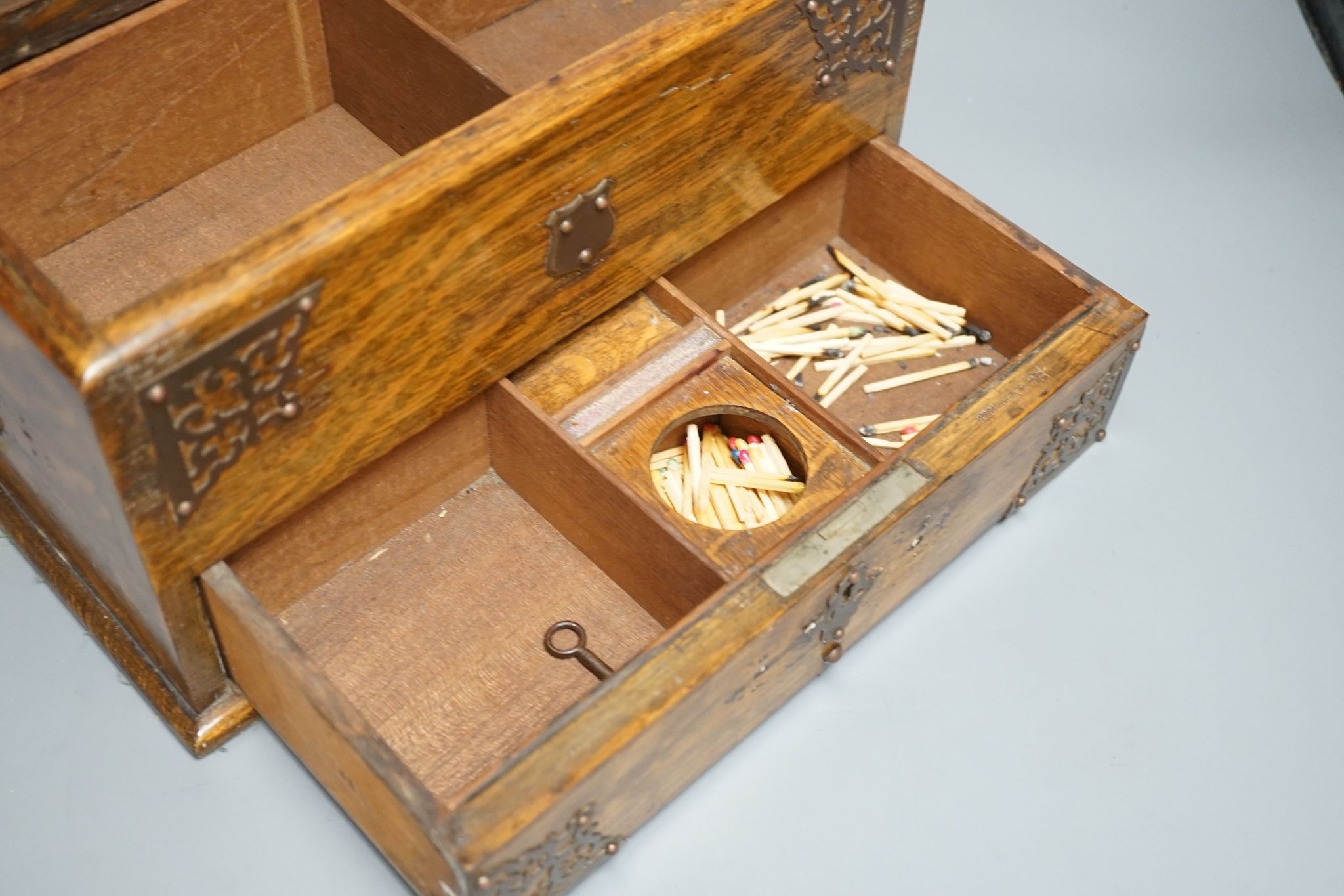 A Victorian oak smoker's box, with brass mounting, 30 cms wide x 17 cms high.
